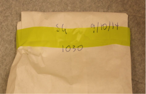 Forensic examination clothing collection photo showing sealed evidence bag