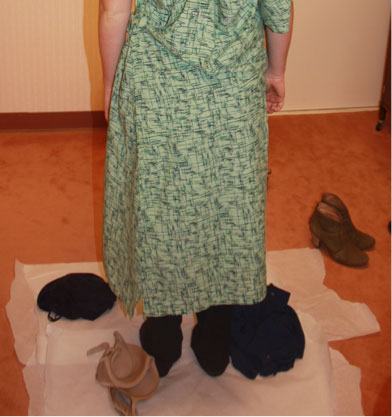 Forensic examination clothing collection photo showing patient disrobing on floor covering