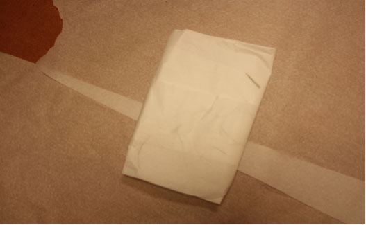 Forensic examination clothing collection photo showing folded floor covering