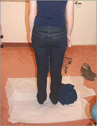 Forensic examination clothing collection photo showing patient disrobing on floor covering